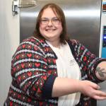 Kayla Brouwer, a volunteer with Special Olympics and a swim coach, took a turn making one of the fundraising donuts at Tim Hortons. (Heather Colpitts/Langley Advance Times)