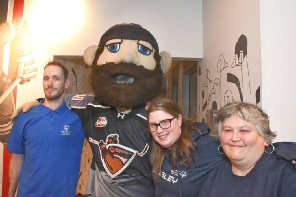 Stephen Metcalfe (left), Marissa Metcalfe, and Jenifer Burton met Jack the mascot of the Vancouver Giants at the launch of the Tim Horton fundraising donut sale to benefit Special Olympics. (Heather Colpitts/Langley Advance Times)