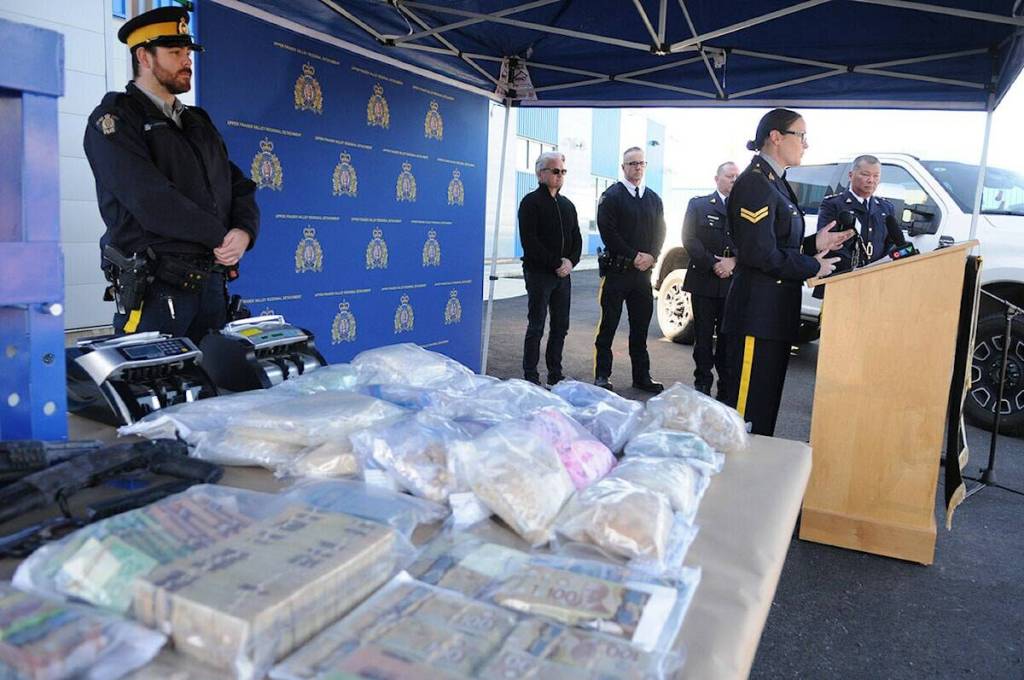 Upper Fraser Valley RCMP Cpl. Carmen Kiener spoke at a press conference in Chilliwack on April 17, 2024, showing some of the items seized from drug bust which included $500,000 in cash, $5 million in street drugs, and $300,000 in vehicles. (Black Press Media files)