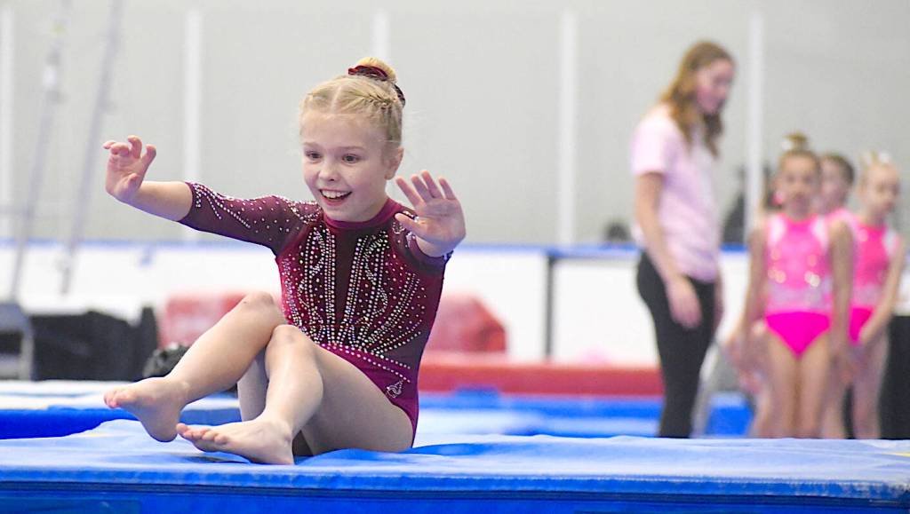 A young competitor beamed as she nailed her landing at the Langley Langley Grand Invitational hosted by the Langley Gymnastics Foundation. (Dan Ferguson/Langley Advance Times)