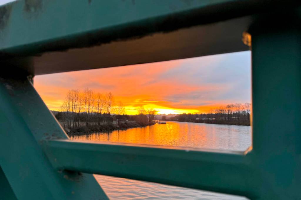 Ken Baber enjoyed a recent sunrise as viewed from between the railings of the Jacob Haldi Bridge in Fort Langley. (Special to Langley Advance Times)