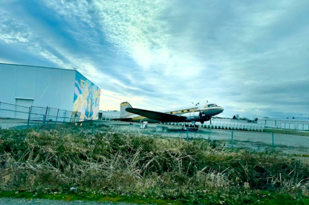 The Douglas DC-3 is parked in front of the women in aviation mural at the Langley Regional Airport. The large, historic aircraft, belonging to the Canadian Museum of Flight, was relocated within the grounds of the airport a little more than a year ago and can now be seen off 216 Street. Darlene Komant recently snapped this photo. (Special to Langley Advance Times)