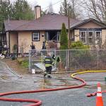 Fire crews mopped up at the site of a structure fire between 240 and 244 Streets on Fraser Highway Saturday morning. RCMP are investigating. (Dan Ferguson/Langley Advance Times)